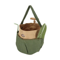 Green carrying bag holding gardening tools with a brown interior on a white background