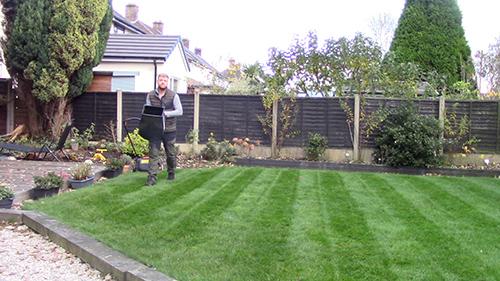 Carrying Grass Clippings Box on lawn